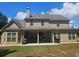 Back exterior elevation showing a spacious yard and covered patio perfect for entertaining at 124 Archstone Sq, Mcdonough, GA 30253