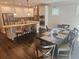 Eat-in kitchen features stainless appliances, granite countertops, island and breakfast nook at 124 Archstone Sq, Mcdonough, GA 30253