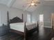Main bedroom boasts a vaulted ceiling, dark wood floors, and ensuite bathroom at 124 Archstone Sq, Mcdonough, GA 30253