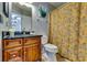 Cozy bathroom with a yellow patterned shower curtain and wood vanity at 2972 Aspen Woods Entry, Atlanta, GA 30360