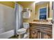 Well-lit bathroom boasts a wood vanity, shower, and warm, inviting colors at 2972 Aspen Woods Entry, Atlanta, GA 30360