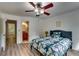 Comfortable bedroom features a floral bedspread, and an ensuite bathroom at 2972 Aspen Woods Entry, Atlanta, GA 30360