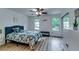 Bright bedroom with floral bedspread, ceiling fan, and large windows at 2972 Aspen Woods Entry, Atlanta, GA 30360