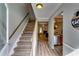 Inviting foyer with beautiful hardwood floors, staircase, and seamless transition to the kitchen at 2972 Aspen Woods Entry, Atlanta, GA 30360