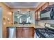 Modern kitchen featuring granite countertops, updated appliances, and stylish pendant lighting at 2972 Aspen Woods Entry, Atlanta, GA 30360