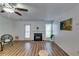 Bright living room features a fireplace, wood flooring, and modern ceiling fan at 2972 Aspen Woods Entry, Atlanta, GA 30360