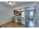 Stylish living area featuring hardwood floors, a breakfast bar, and seamless flow to the entryway at 2972 Aspen Woods Entry, Atlanta, GA 30360