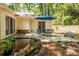 A backyard with an outdoor dining area and serene pond feature at 5410 Rosser Rd, Stone Mountain, GA 30087