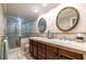 Luxurious bathroom with dual sinks, a glass-enclosed shower, and elegant tile work exudes sophistication at 5410 Rosser Rd, Stone Mountain, GA 30087