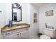 Bathroom featuring vanity with granite countertop, white cabinets, and a decorative mirror at 5410 Rosser Rd, Stone Mountain, GA 30087