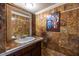 Ornate powder room featuring decorative tiling, custom vanity, and elegant accents at 5410 Rosser Rd, Stone Mountain, GA 30087