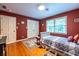 Cozy bedroom with hardwood floors, a comfortable bed, and ample natural light from the window at 5410 Rosser Rd, Stone Mountain, GA 30087