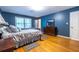 Spacious bedroom with hardwood floors, blue walls, and large windows providing natural light at 5410 Rosser Rd, Stone Mountain, GA 30087