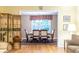 View of the dining room from the living room, showcasing hardwood floors and a large window at 5410 Rosser Rd, Stone Mountain, GA 30087
