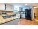 Bright kitchen featuring granite countertops, white cabinets and black appliances at 5410 Rosser Rd, Stone Mountain, GA 30087