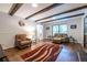 Bright living room features hardwood floors, beamed ceiling, and ample seating for relaxation at 5410 Rosser Rd, Stone Mountain, GA 30087