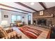 Inviting living room with a brick fireplace, wood beams, and hardwood floors at 5410 Rosser Rd, Stone Mountain, GA 30087