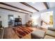 Comfortable living room featuring hardwood floors, beamed ceiling, and ample seating for relaxation at 5410 Rosser Rd, Stone Mountain, GA 30087