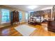 Charming main bedroom boasts a brick accent wall, hardwood floors, and ample natural light at 5410 Rosser Rd, Stone Mountain, GA 30087