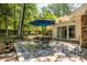 Relaxing outdoor patio with decorative stone flooring and a lush green backyard at 5410 Rosser Rd, Stone Mountain, GA 30087