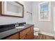Modern bathroom vanity features granite countertops, a large mirror and views out to the backyard at 108 Deer Creek Run, Moreland, GA 30259