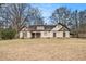 Charming one-story home featuring Tudor-style accents, a dormer, and a well-maintained front yard at 108 Deer Creek Run, Moreland, GA 30259
