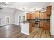 Modern kitchen with wood cabinets, stainless steel appliances, breakfast bar, and stylish lighting at 108 Deer Creek Run, Moreland, GA 30259