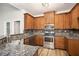 Well-equipped kitchen boasts granite countertops, stainless steel appliances, and ample cabinet space at 108 Deer Creek Run, Moreland, GA 30259