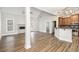 Bright open-concept living space featuring a stone fireplace, hard wood floors, and an open kitchen at 108 Deer Creek Run, Moreland, GA 30259