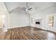 Spacious living room boasts a ceiling fan, fireplace, wood floors, and a bright, airy ambiance at 108 Deer Creek Run, Moreland, GA 30259