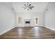 Bright living room features a ceiling fan, fireplace, wood floors, and natural light at 108 Deer Creek Run, Moreland, GA 30259