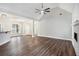 Open-concept living room with wood floors, fireplace, and stylish lighting at 108 Deer Creek Run, Moreland, GA 30259