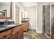 Well lit bathroom with dual sink vanities, granite countertops and a tiled walk-in shower at 108 Deer Creek Run, Moreland, GA 30259