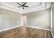 Spacious main bedroom with tray ceilings and hard wood floors, with a door to ensuite at 108 Deer Creek Run, Moreland, GA 30259
