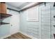 Spacious walk-in pantry with wood-look floors, ample shelving, and natural light from a window at 108 Deer Creek Run, Moreland, GA 30259