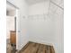 Walk-in pantry featuring wood-look floors, white walls, and wire shelving at 108 Deer Creek Run, Moreland, GA 30259
