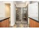 Tiled walk-in shower in ensuite bathroom featuring a bench and glass door enclosure at 108 Deer Creek Run, Moreland, GA 30259