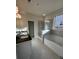 Modern bathroom with dual sink vanity, soaking tub, glass shower, and neutral tile at 3806 Lockaby Way, Lawrenceville, GA 30044