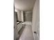 Bathroom featuring a shower-tub combo, single sink vanity, and tile flooring at 3806 Lockaby Way, Lawrenceville, GA 30044