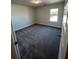 Cozy bedroom featuring neutral walls, plush carpeting, and a window for natural light at 3806 Lockaby Way, Lawrenceville, GA 30044