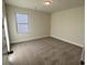 Inviting bedroom with a neutral color scheme, plush carpeting, and a bright window at 3806 Lockaby Way, Lawrenceville, GA 30044