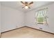 Simple bedroom with carpet, ceiling fan, and bright window at 57 Fair Oaks Se Dr, Conyers, GA 30094