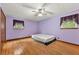 Spacious bedroom with hardwood floors, ceiling fan, and two windows that bring in natural light at 57 Fair Oaks Se Dr, Conyers, GA 30094