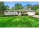Charming single-story home with a well-manicured lawn and mature trees at 57 Fair Oaks Se Dr, Conyers, GA 30094