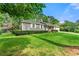 Well-maintained home featuring lush green lawn and mature landscaping at 57 Fair Oaks Se Dr, Conyers, GA 30094