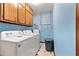 Laundry room with side by side washer and dryer and blue walls at 57 Fair Oaks Se Dr, Conyers, GA 30094