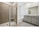 Bright bathroom featuring a tiled shower with glass door, a soaking tub, and a double sink vanity with granite countertop at 62 Hampton Ter, Dallas, GA 30157