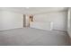 Open bonus room with neutral carpet, white walls, and a view of the landing at 62 Hampton Ter, Dallas, GA 30157