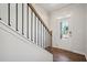 Bright entryway features wood floors, iron railing staircase, and a glass-paneled front door at 62 Hampton Ter, Dallas, GA 30157