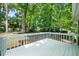 White fenced back deck ideal for relaxing and enjoying a private, wooded view at 1359 Chatley Way, Woodstock, GA 30188